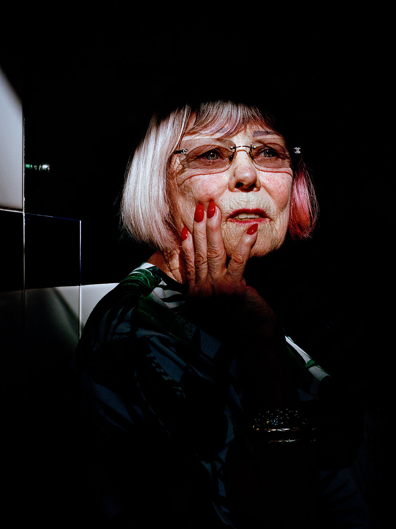 A woman with her hand on her face.