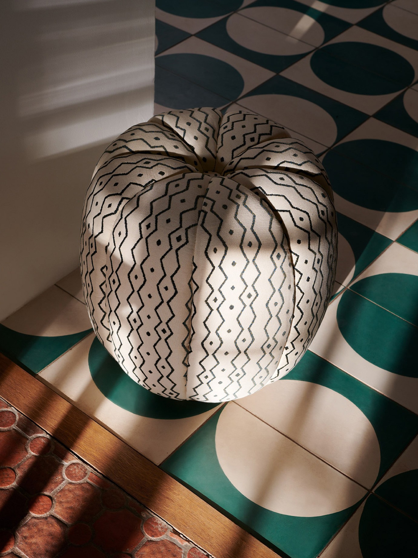 A white footstool in sunlight.