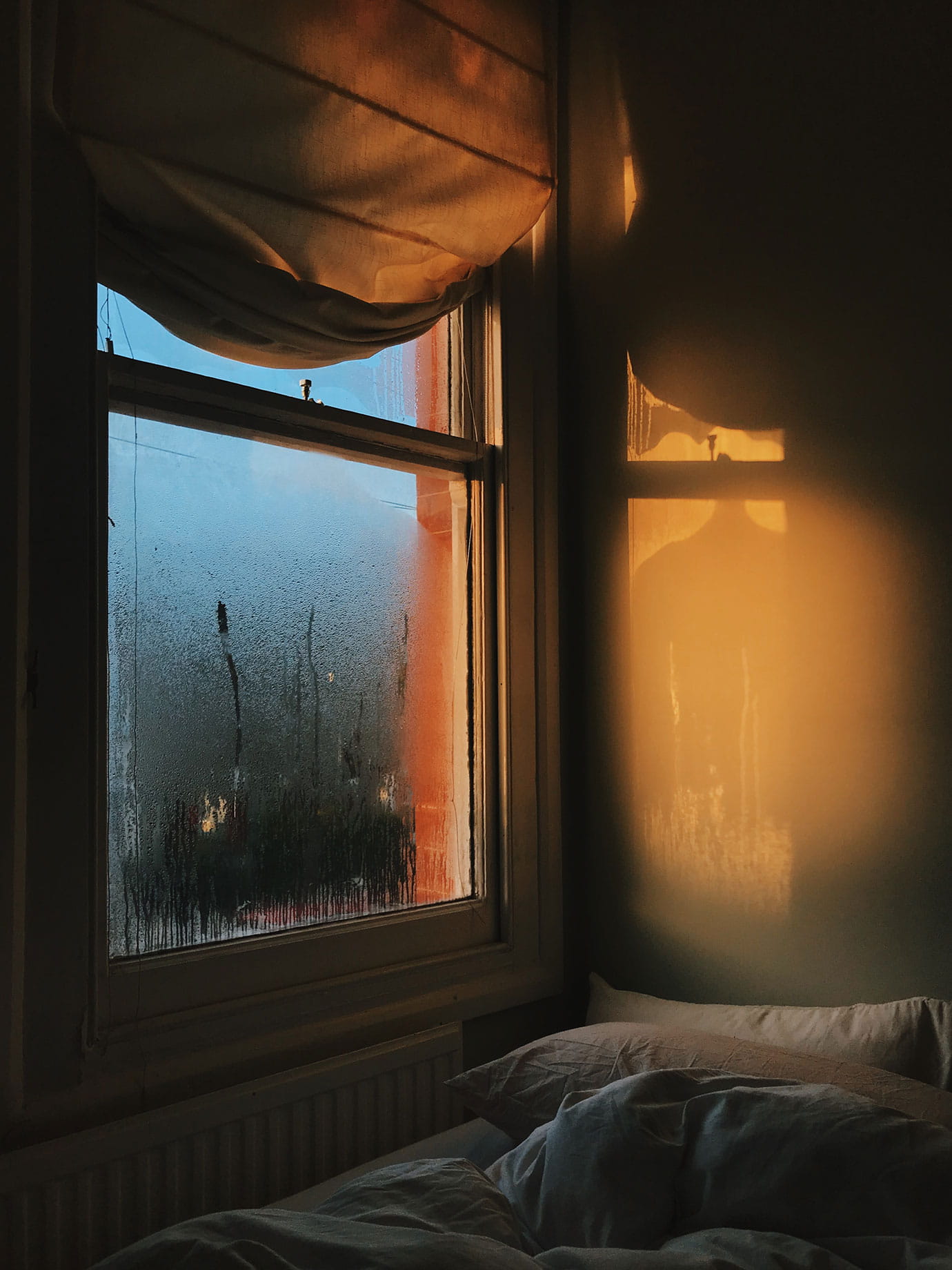 A bedroom window with dawn light.