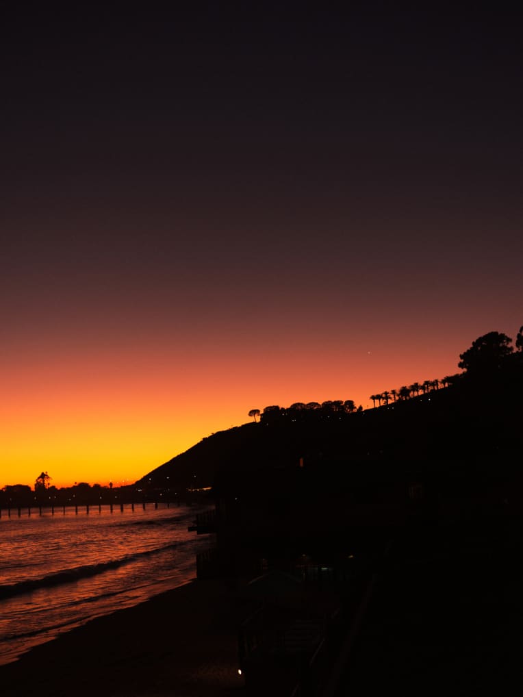 A beach and hill at night.