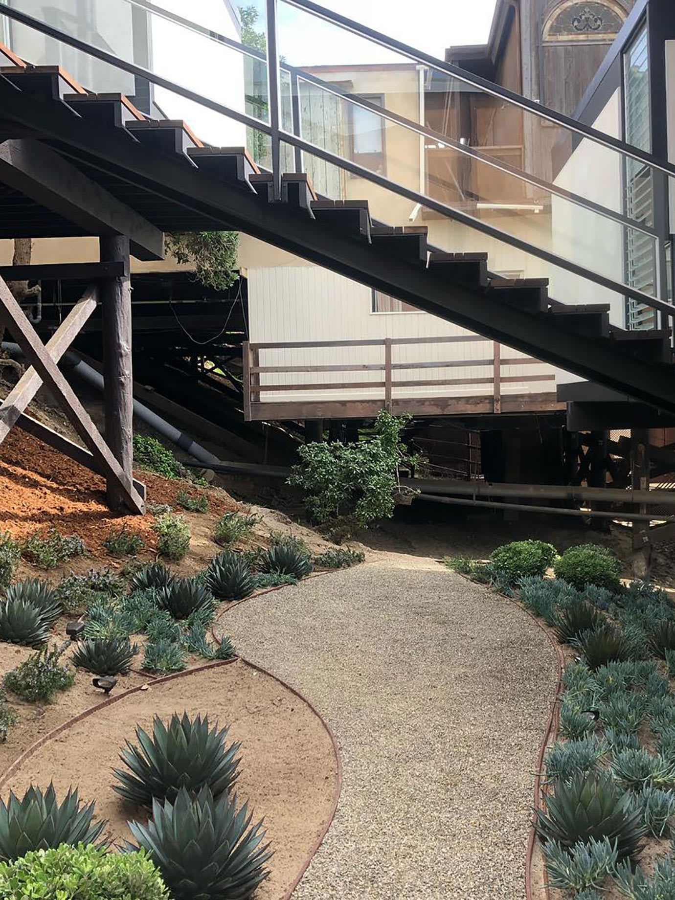 The exterior of a modernist house and its garden.