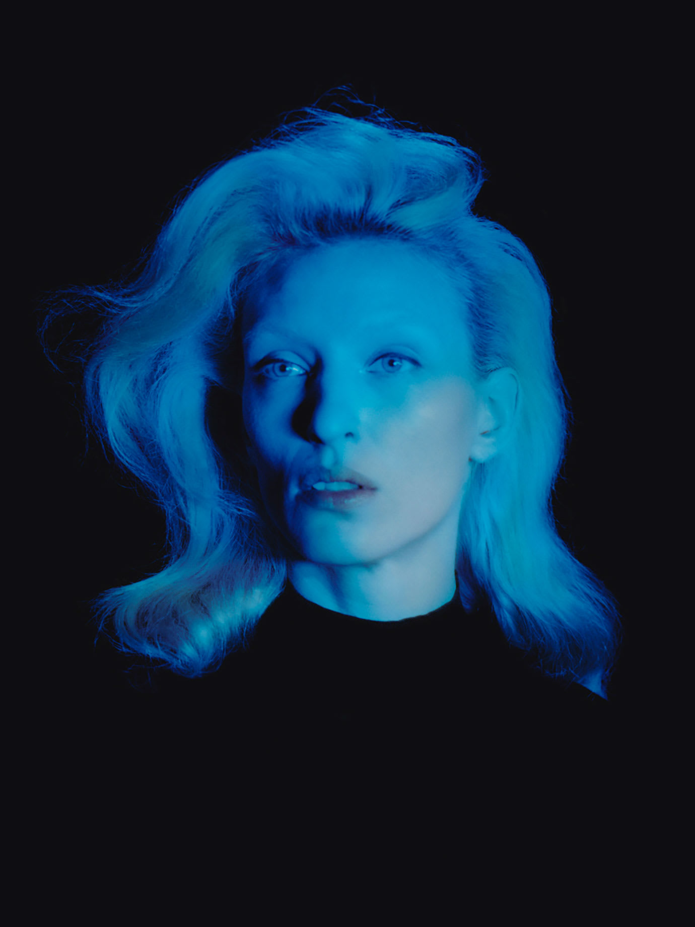 A blonde woman with a blue light on her.