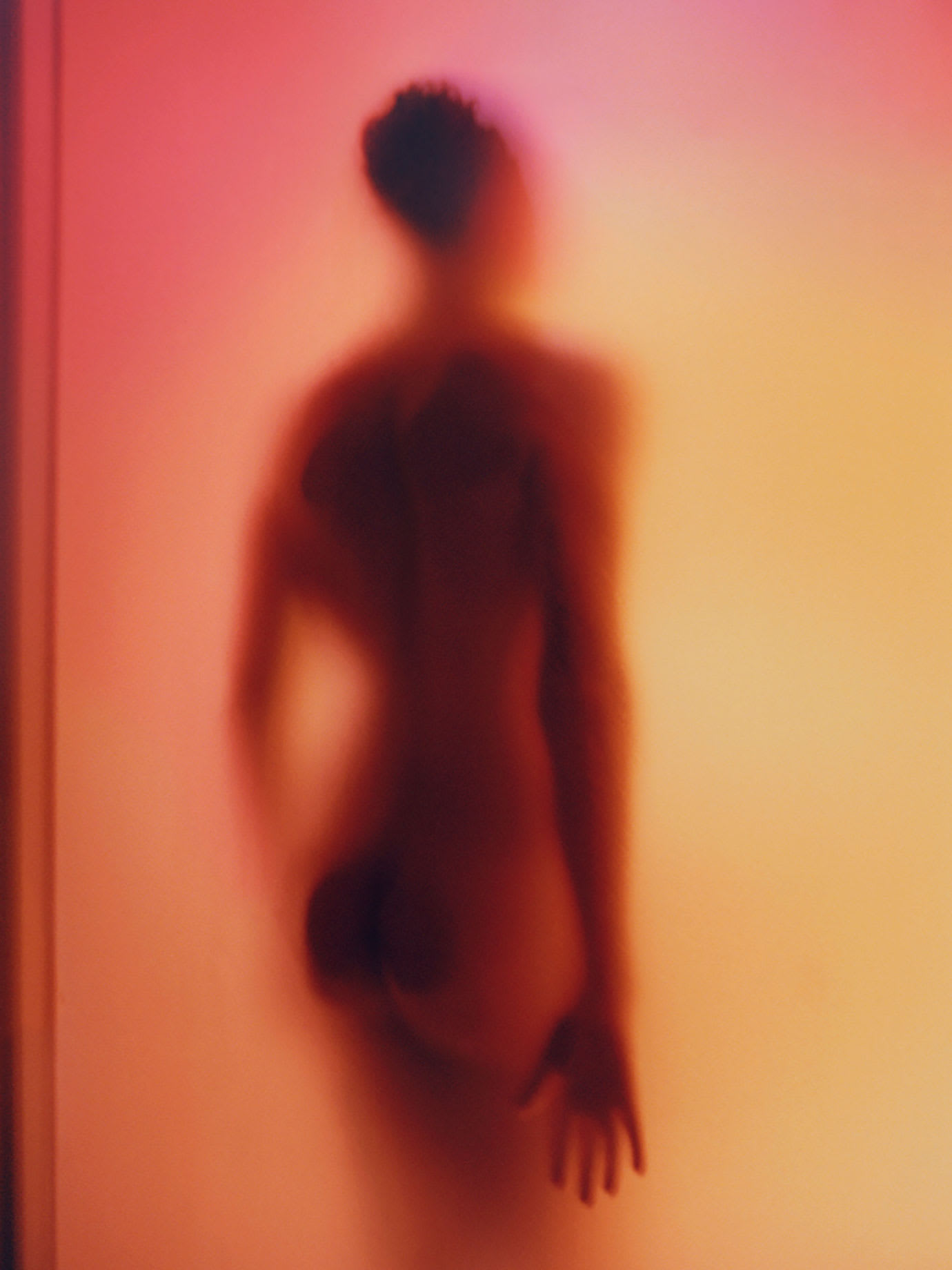 The shape of a man through glass.