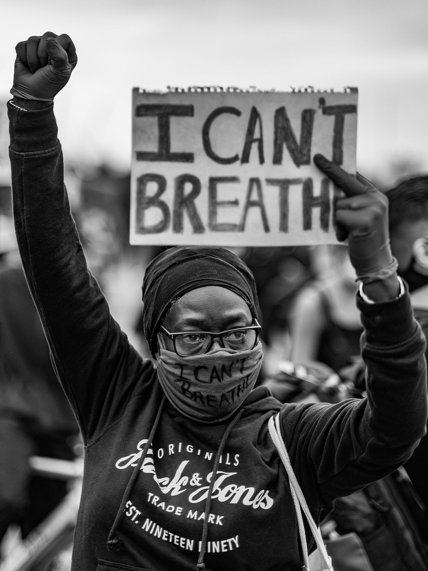 A person holding a sign with I can't breathe written on it.