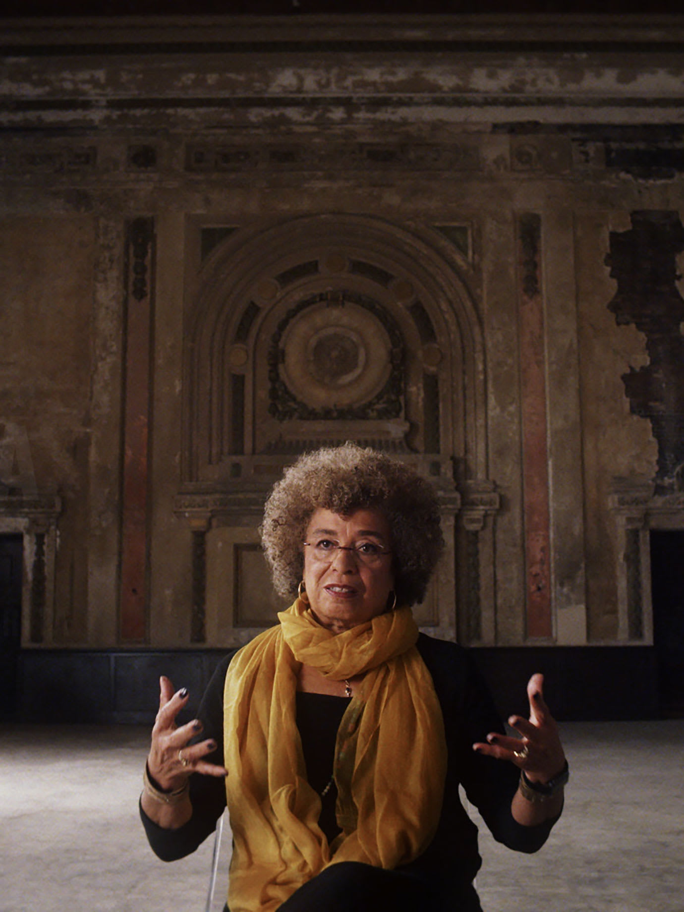 A woman in a large high ceilinged room.