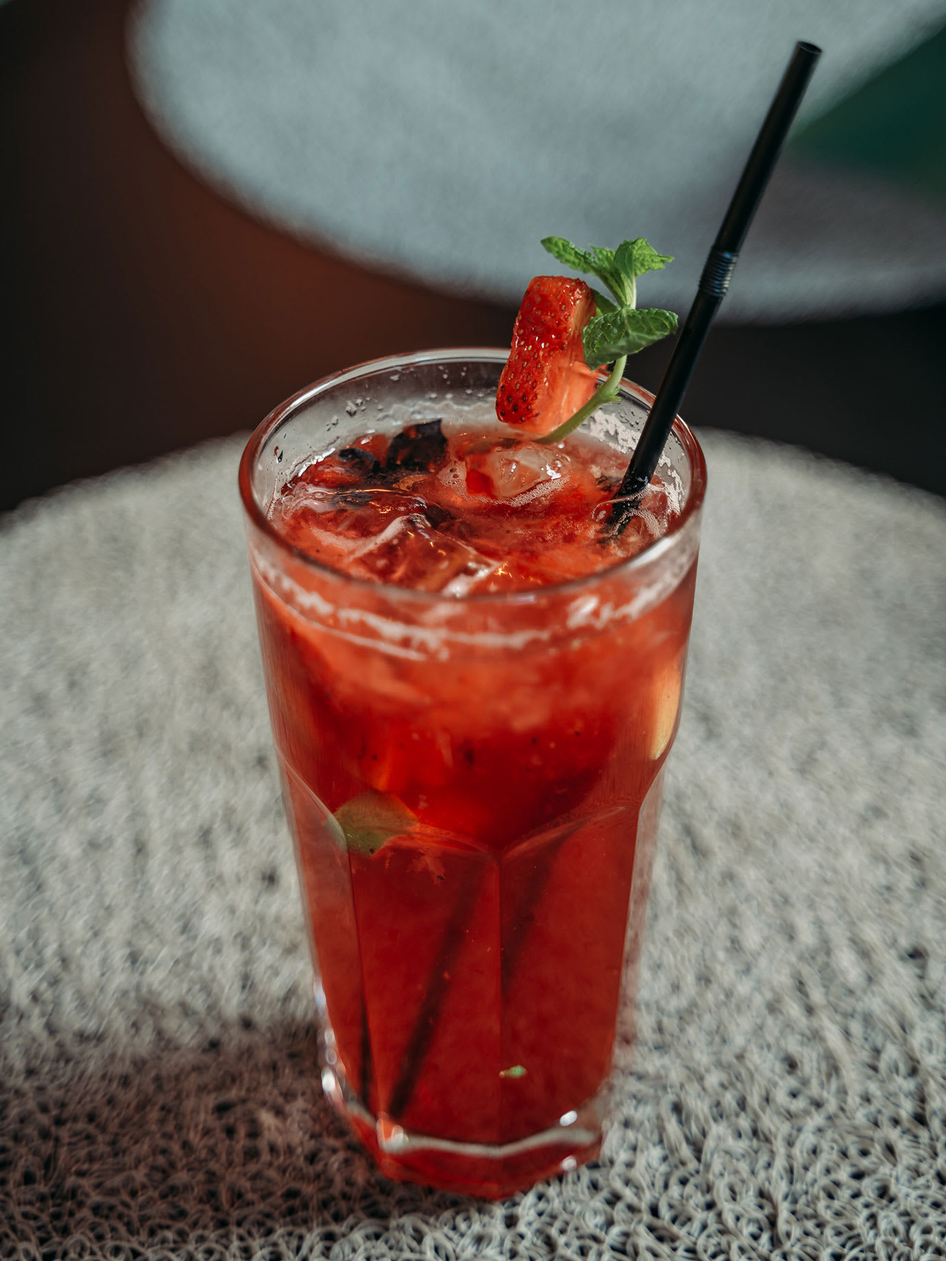 A glass of red strawberry lemonade.