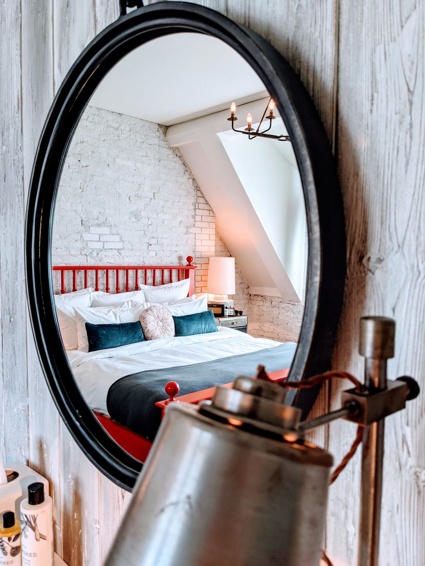 A bed reflected in a mirror.