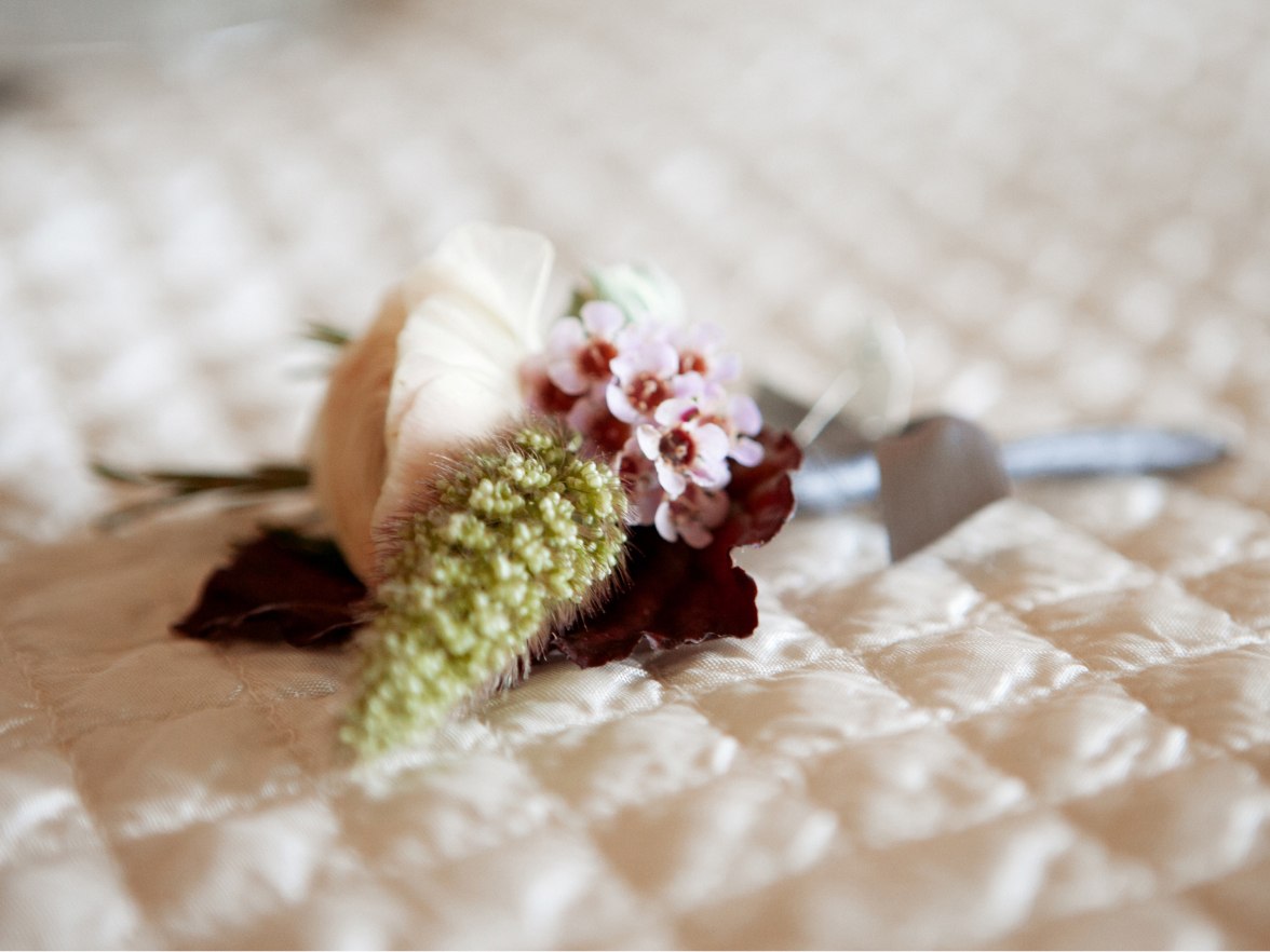 A wedding bouquet on a bed.