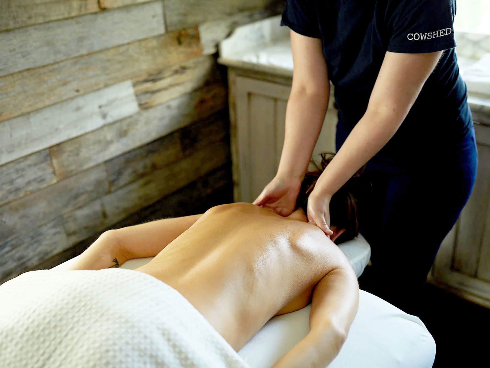 A woman receiving a massage in a spa.