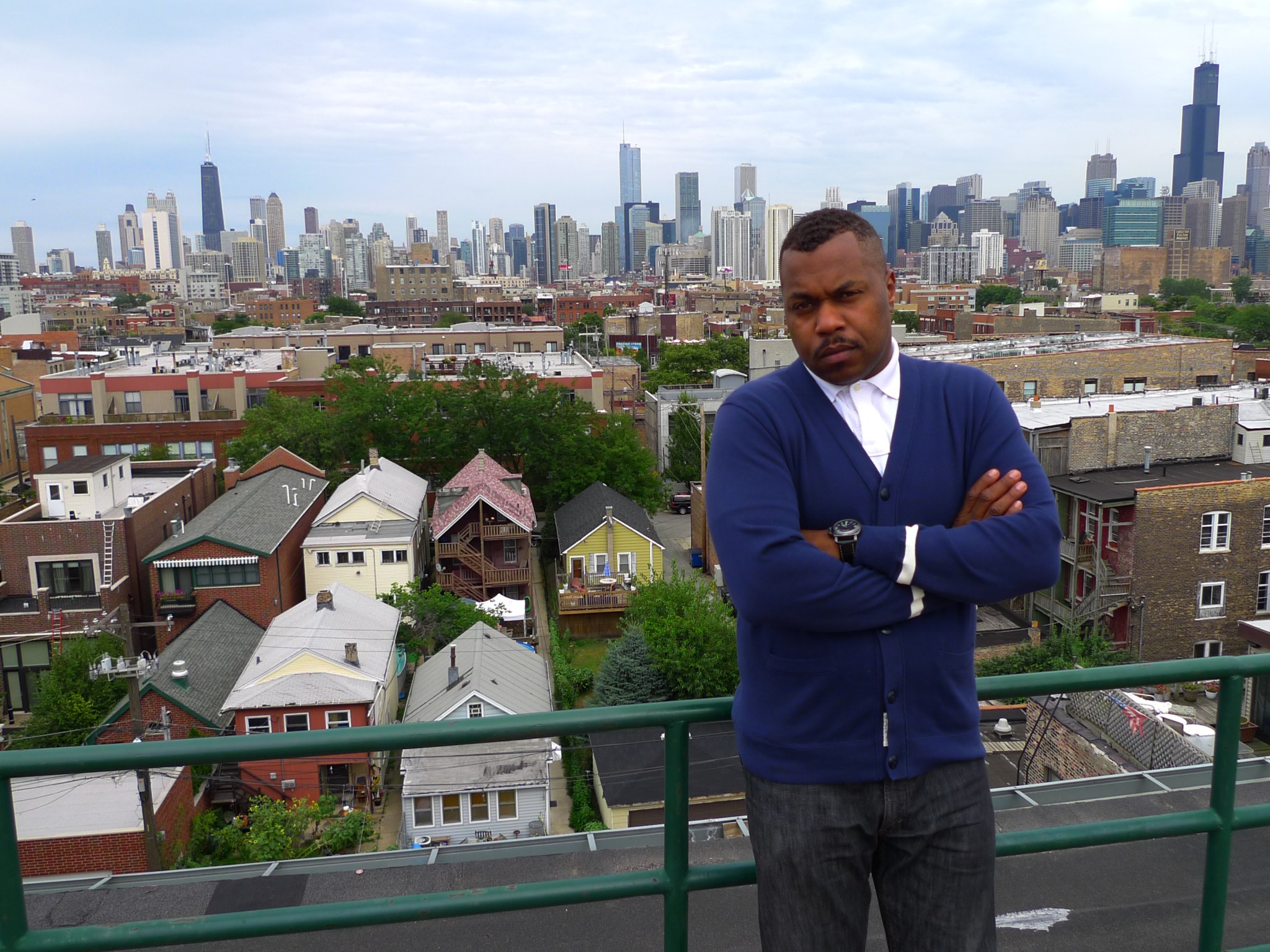 man on roof against city skyline