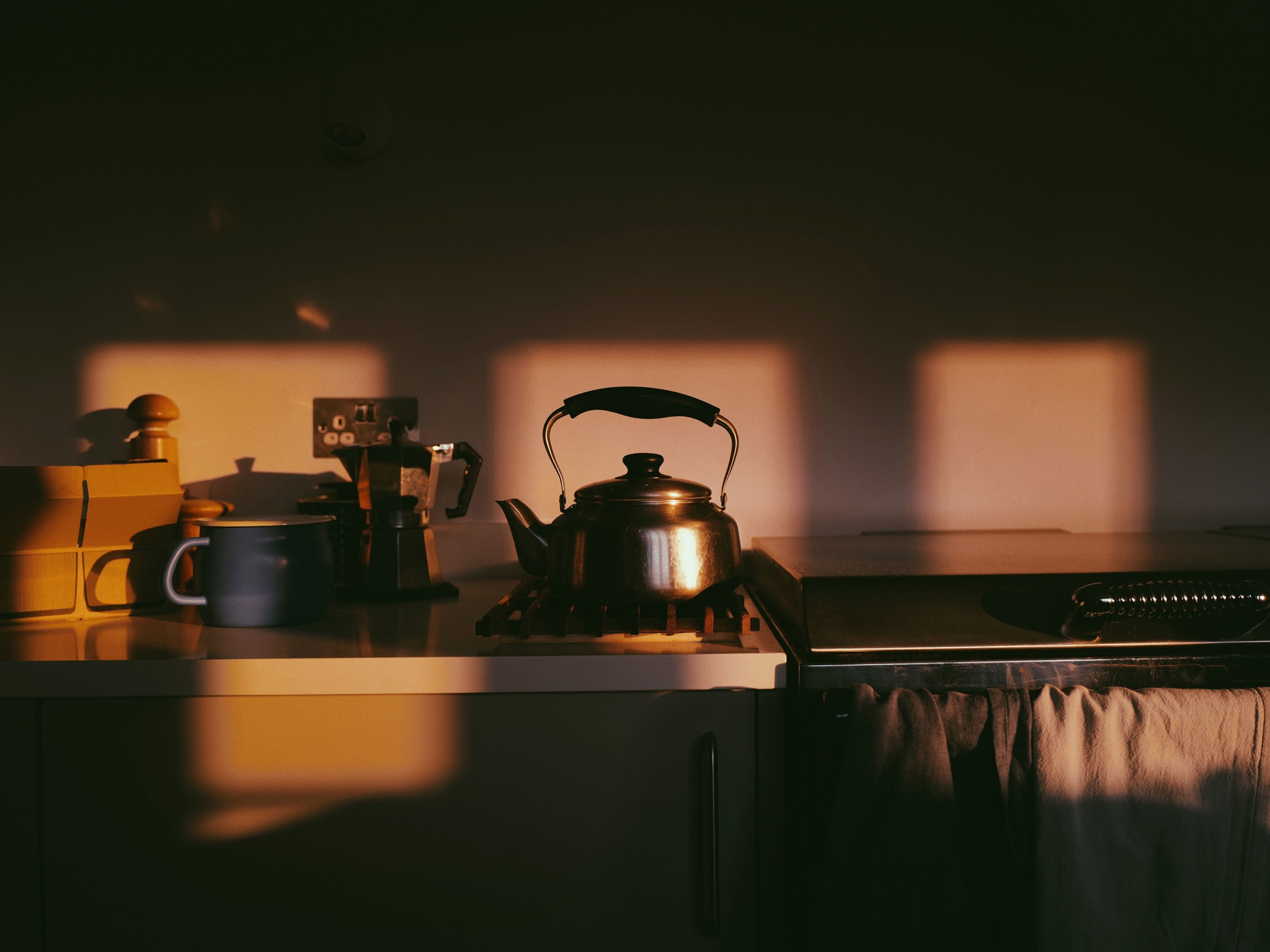 A kettle in a kitchen in the morning light.