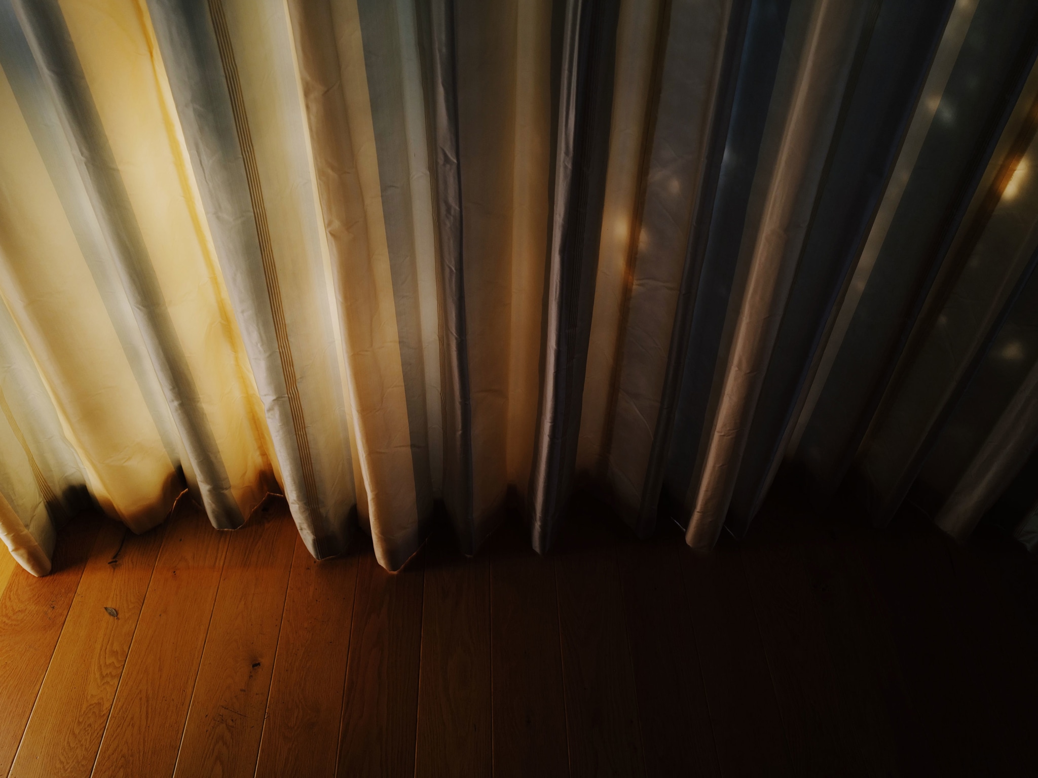 Curtains with sunset light on them.