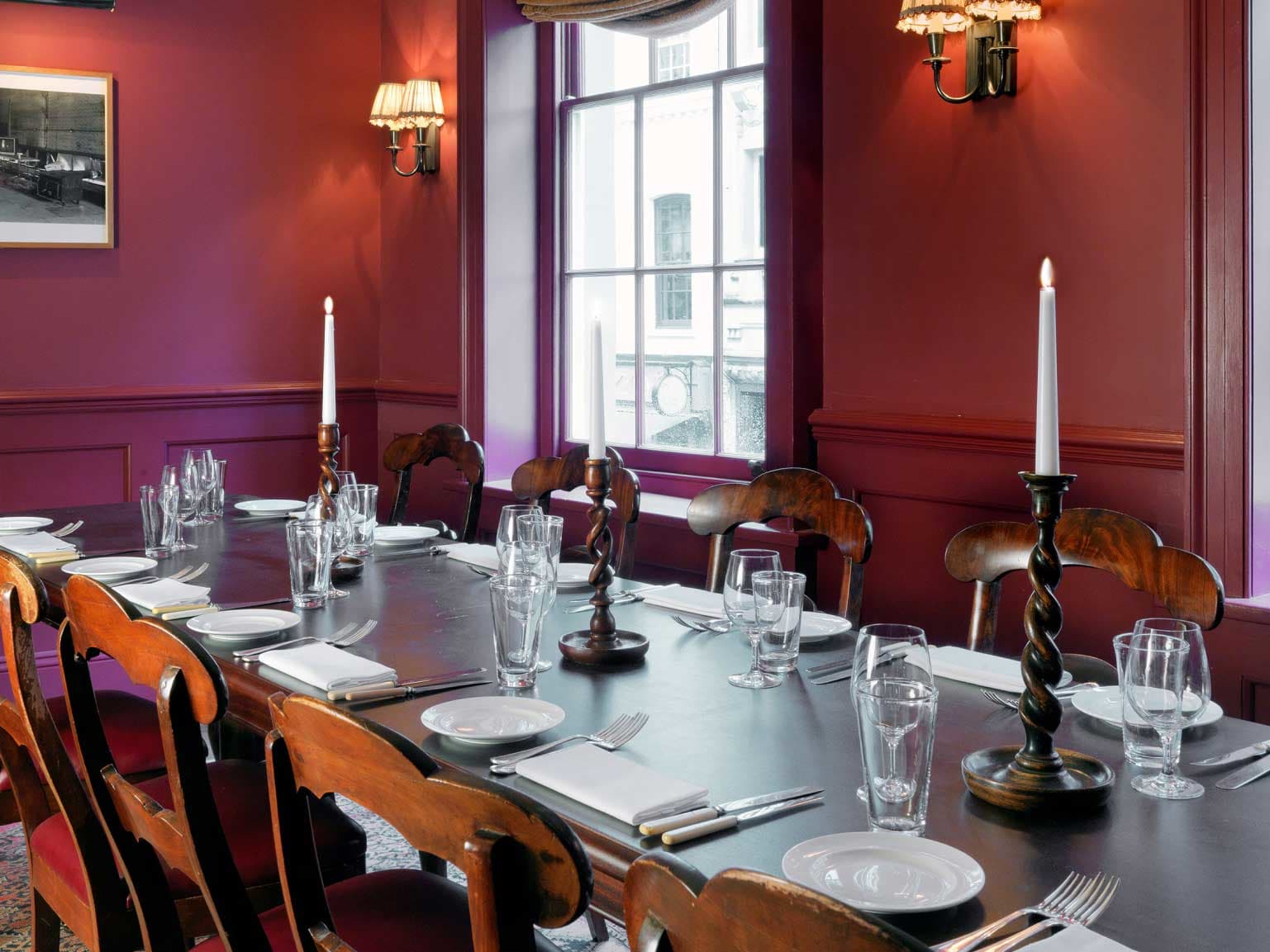 .A red room with a large dining table in it.