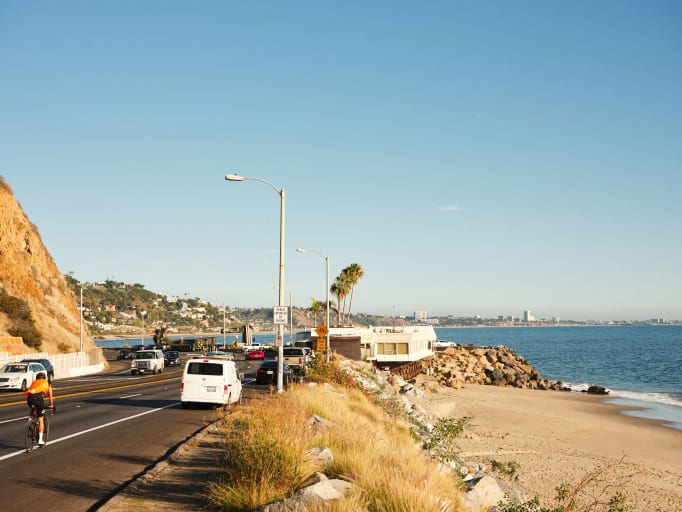 A coastal highway with cars next to the sea.