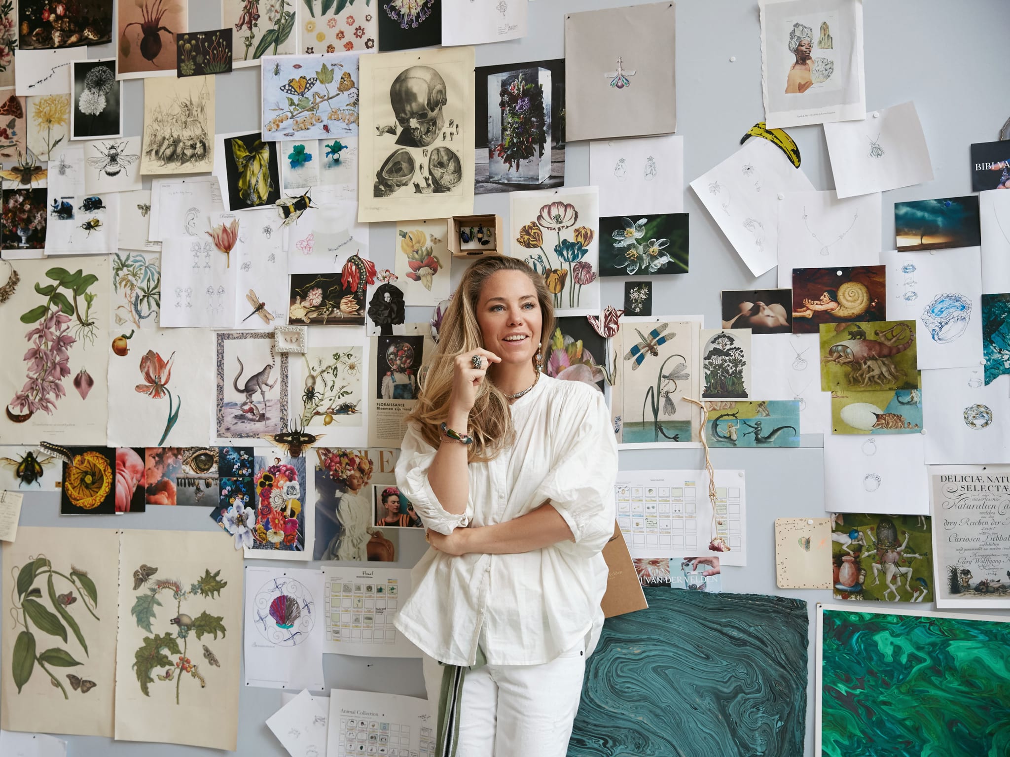 A woman standing in front of a mood board.