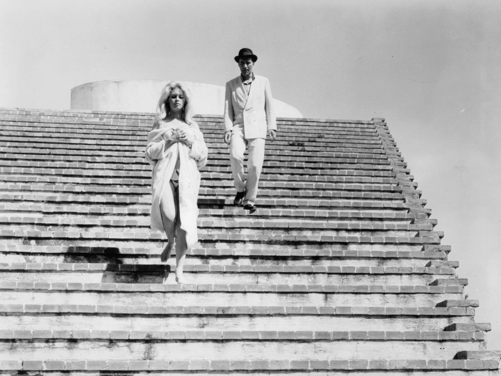 A woman and man walking down a wide outdoor staircase.