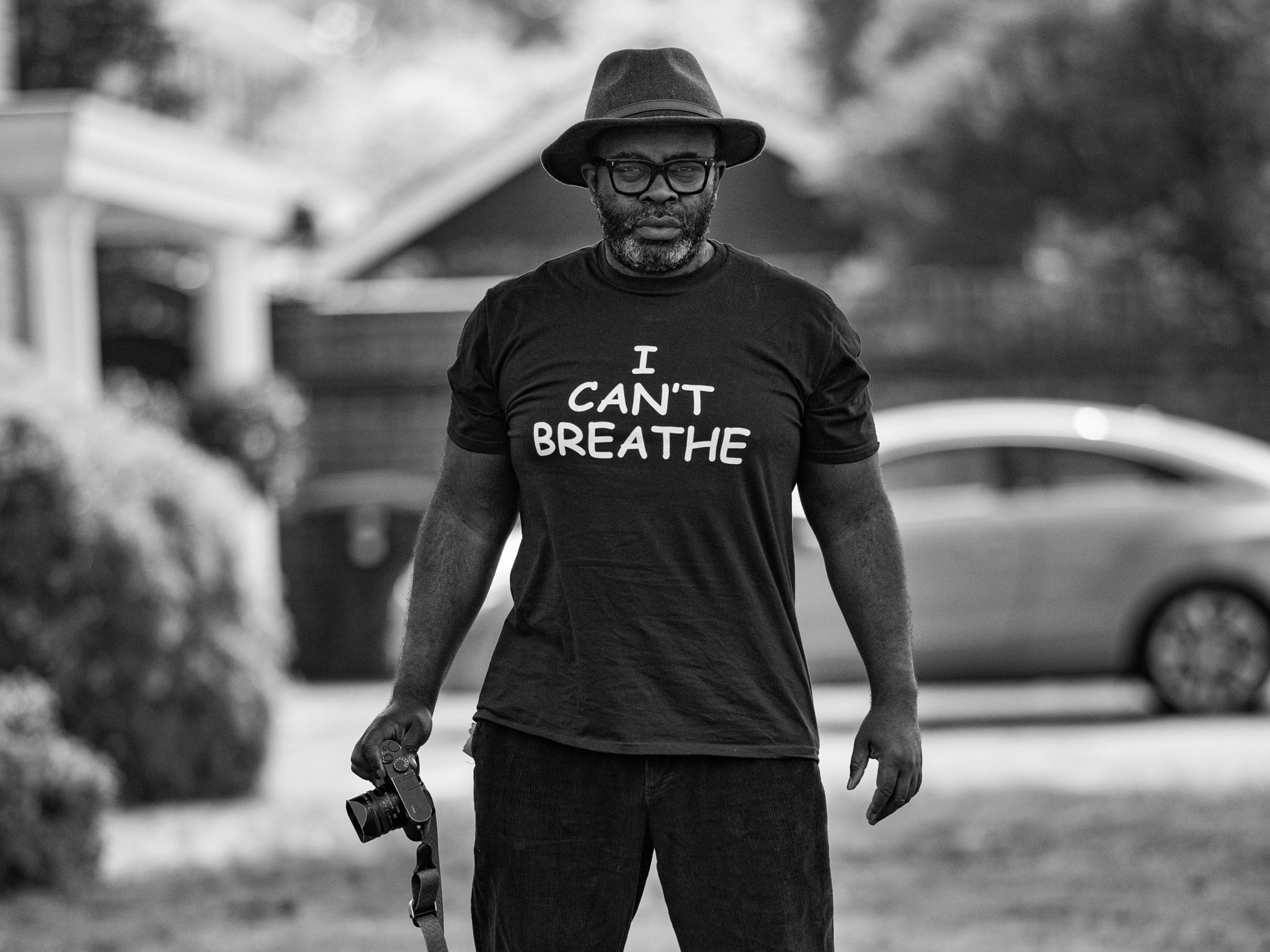 A man with a camera wearing a t-shirt with I Can't Breathe printed on it.