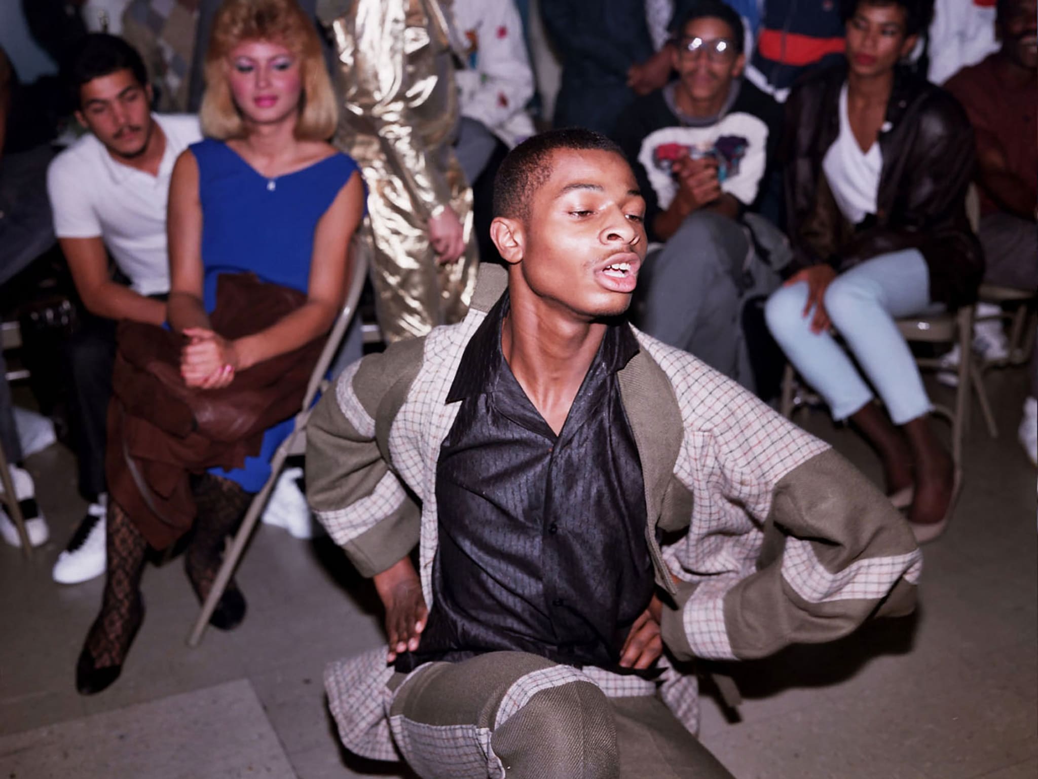A group of people watching a man dance.