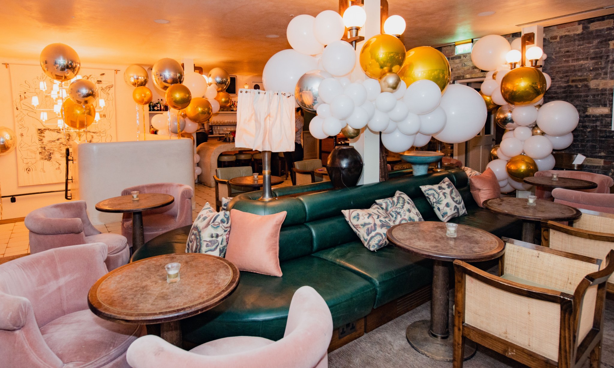 A lounge-like interior full of balloons.