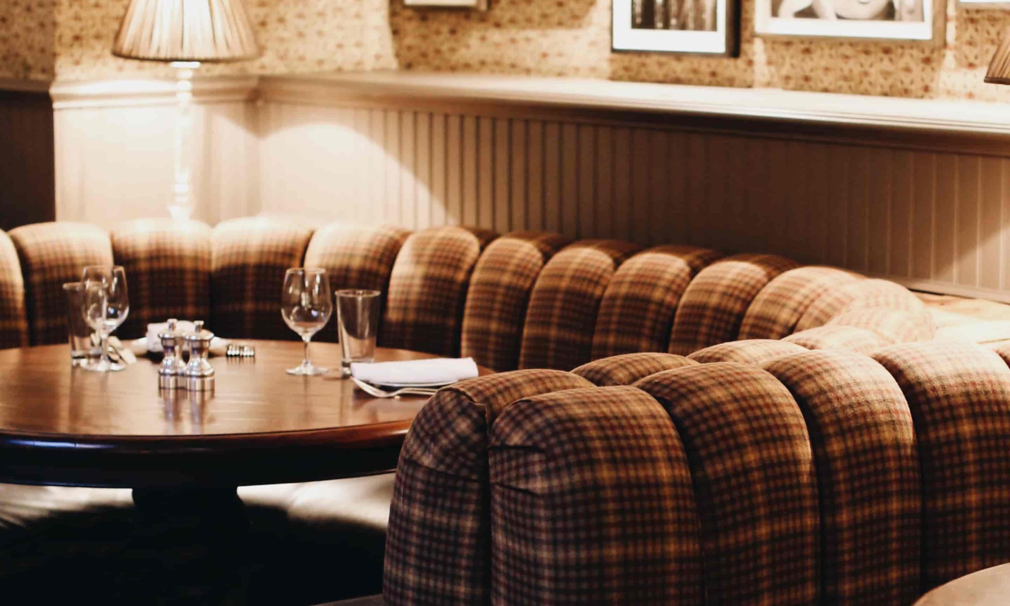 A warmley lit dining space with booths.