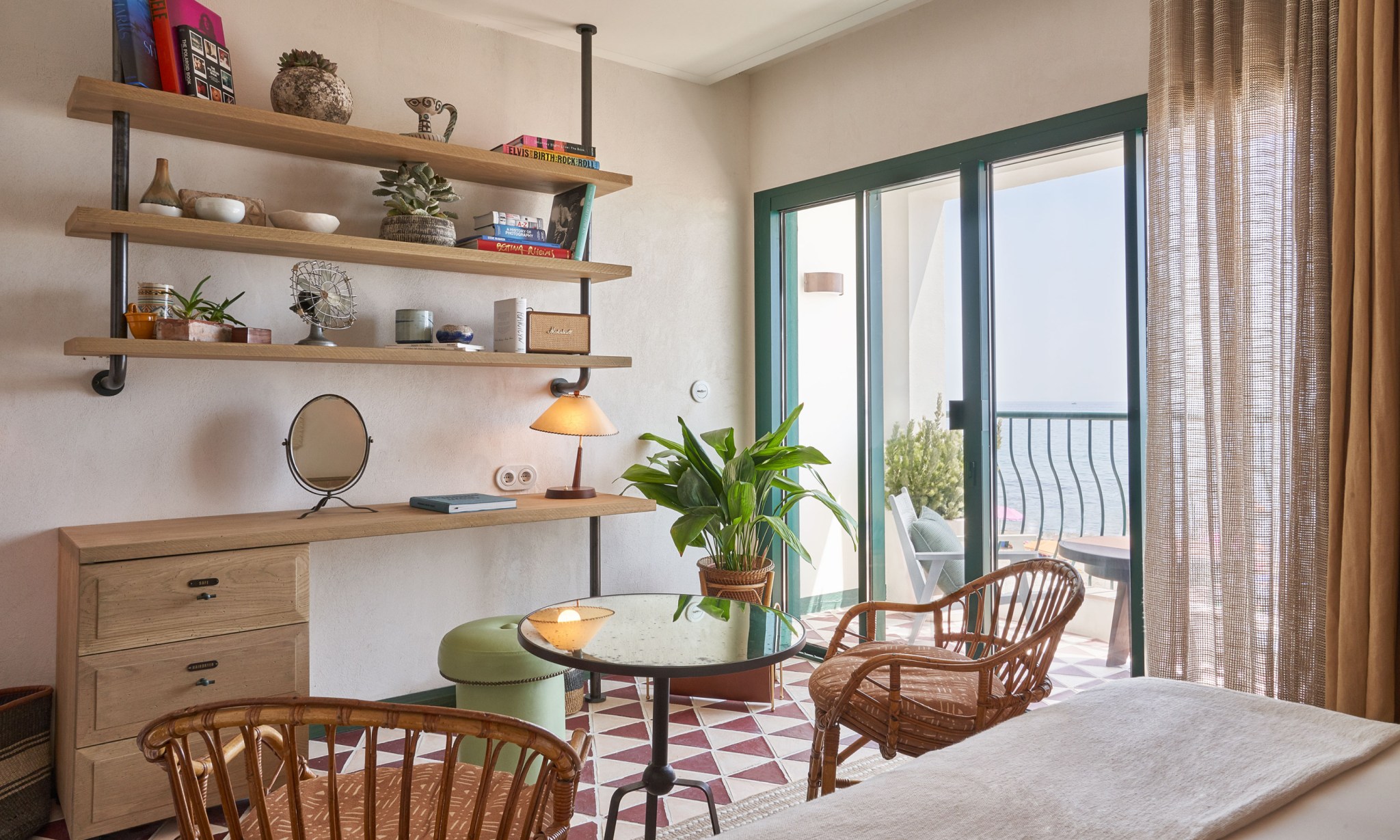 The interior of a bedroom overlooking the sea.