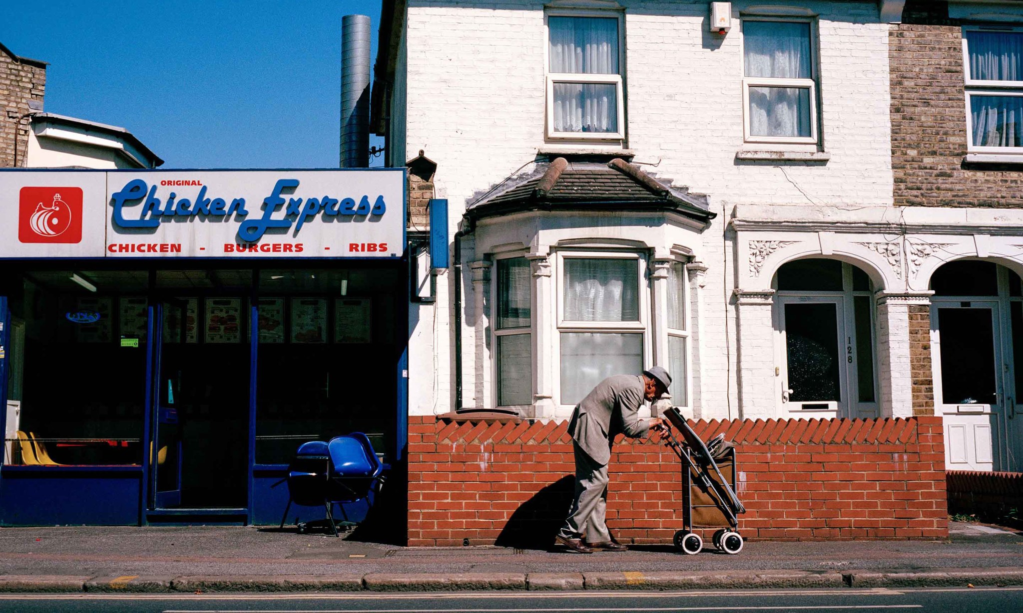 An old man walking down a street.