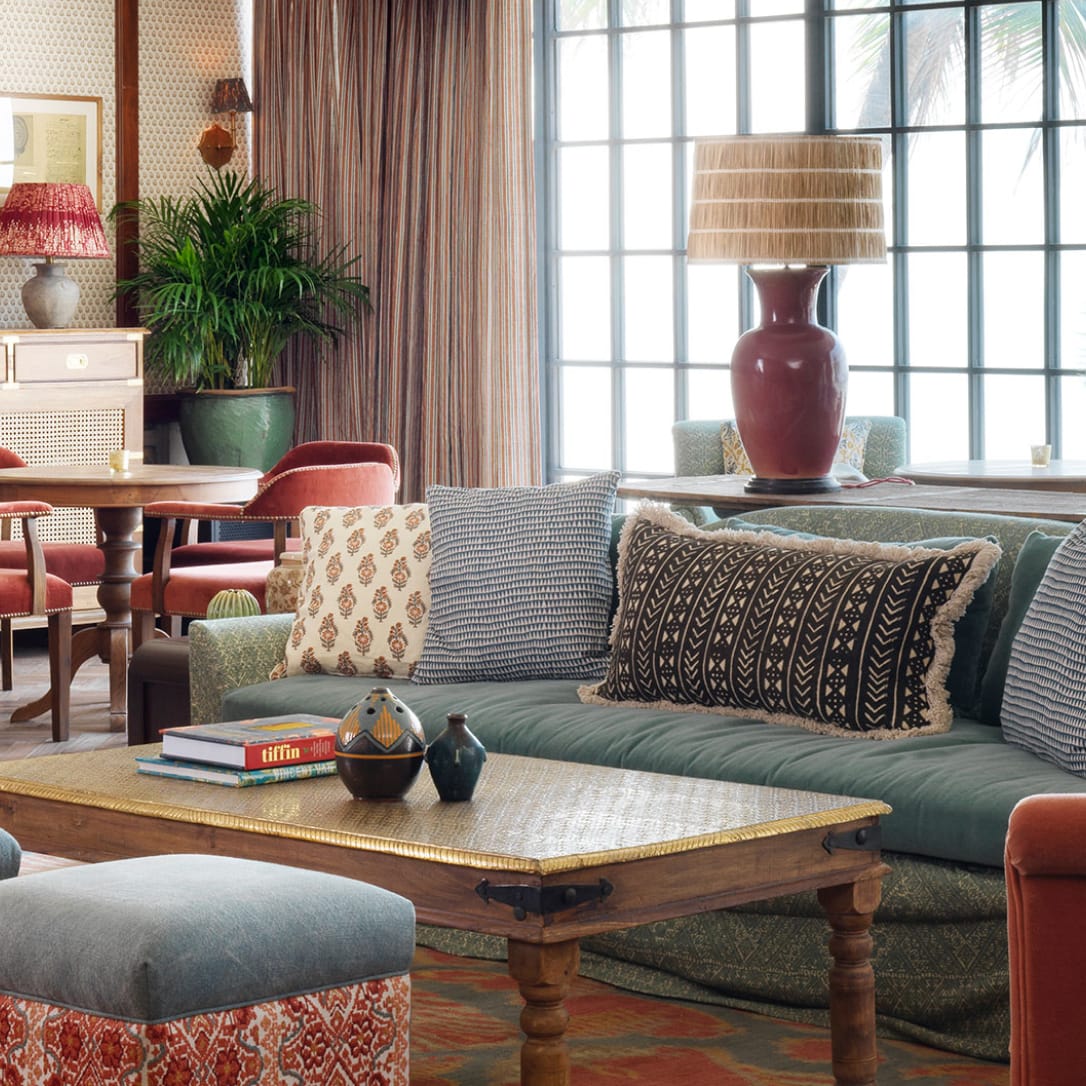 A lounge-like interior with large sofas and cushions.