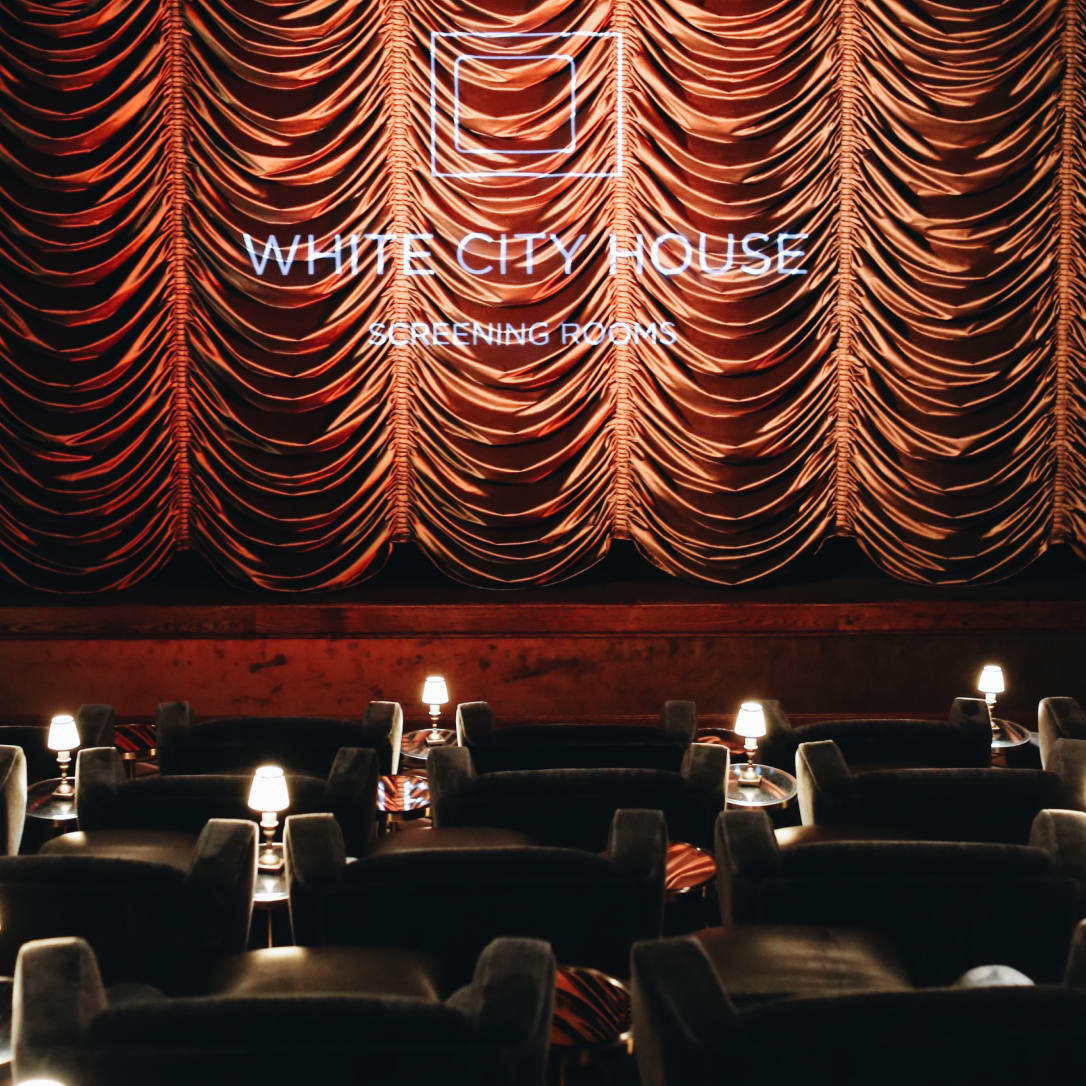 A red curtain down on a cinema screen.