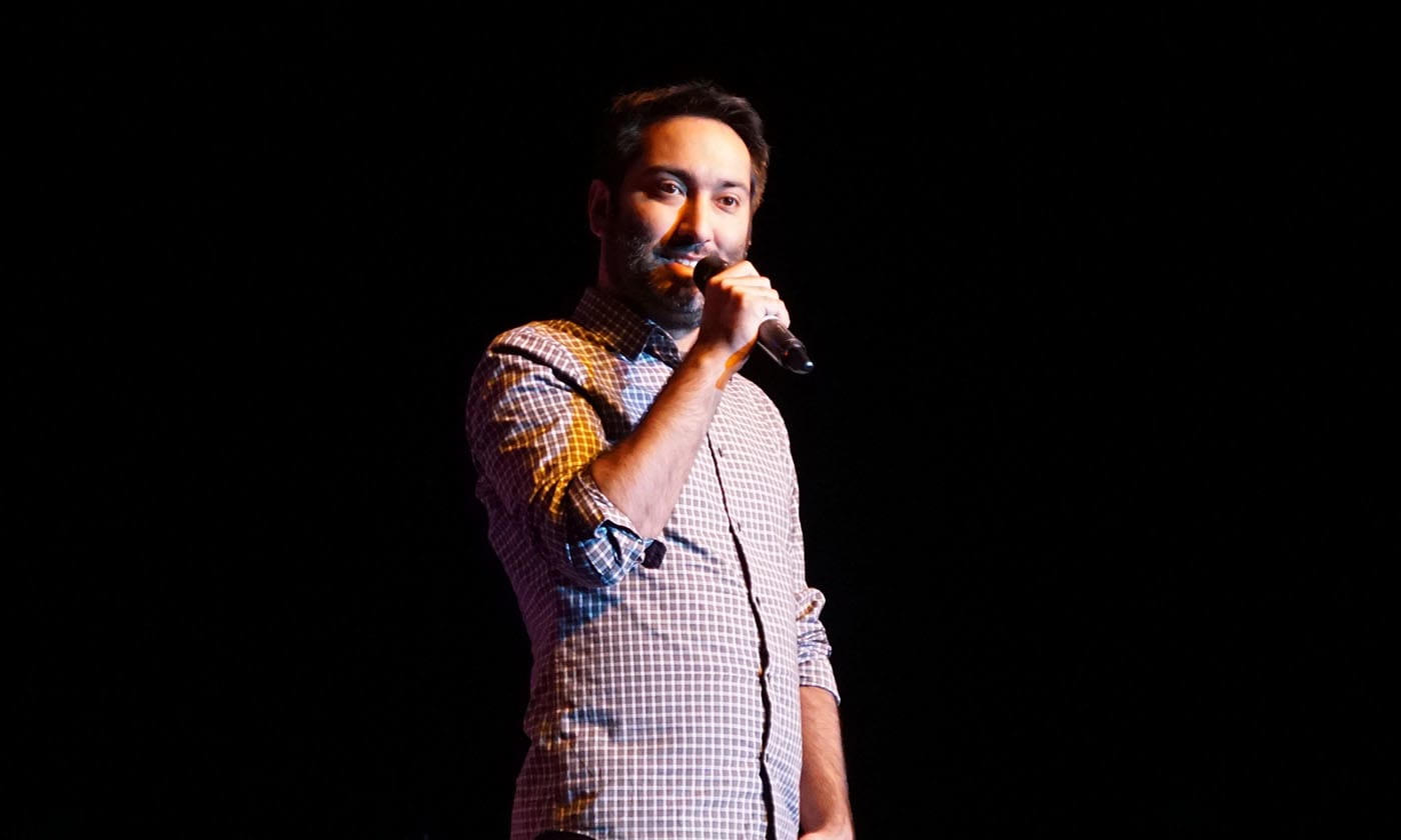 man on mic on stage