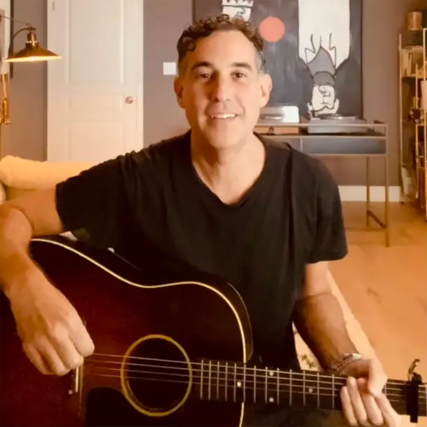A man playing an acoustic guitar.