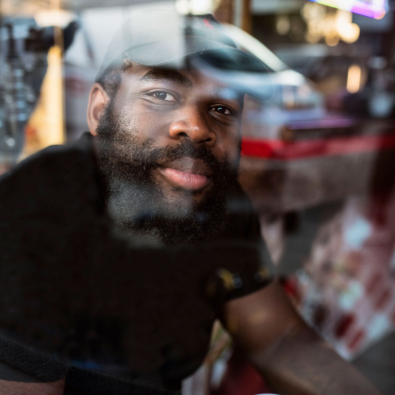 A man sitting on the other side of a cafe window.