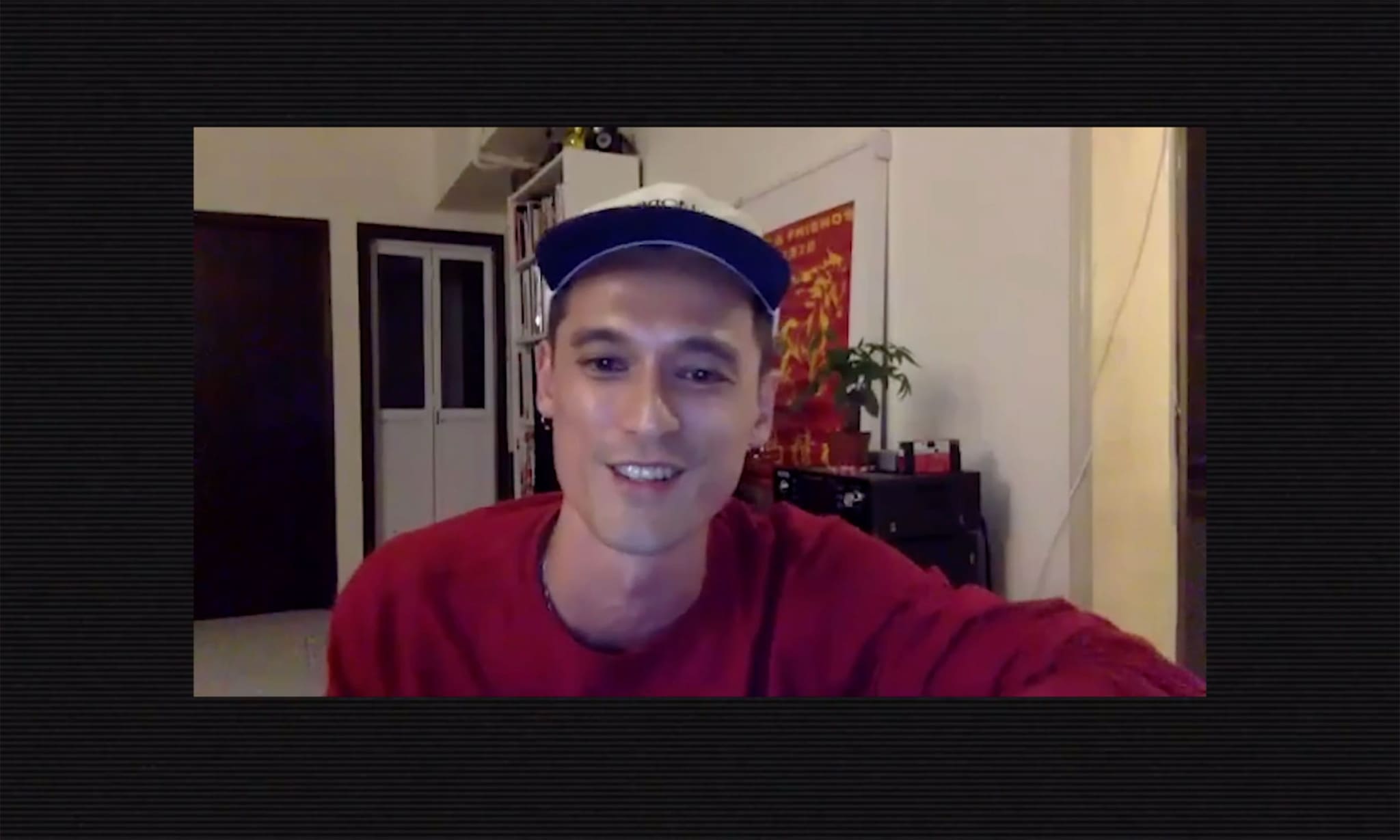 A man smiling during a video call.