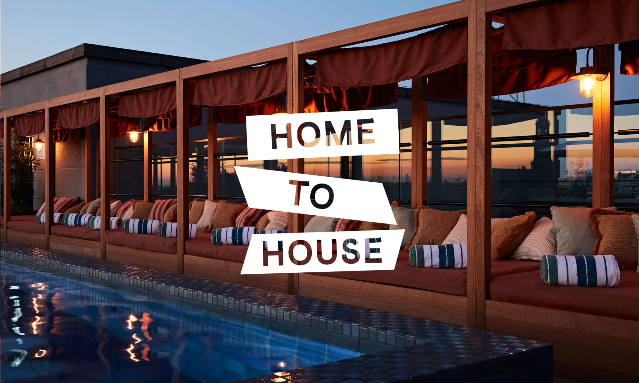 A rooftop pool and day beds at sunset with a Home To House logo on top of it.