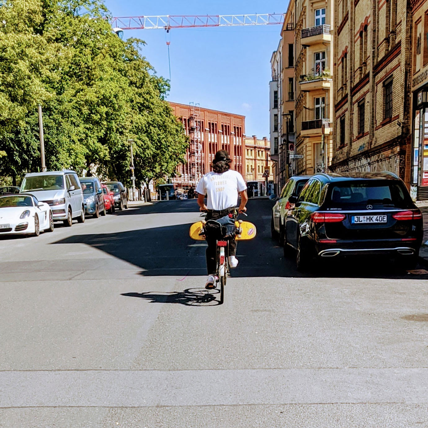A person cycling down a city street.