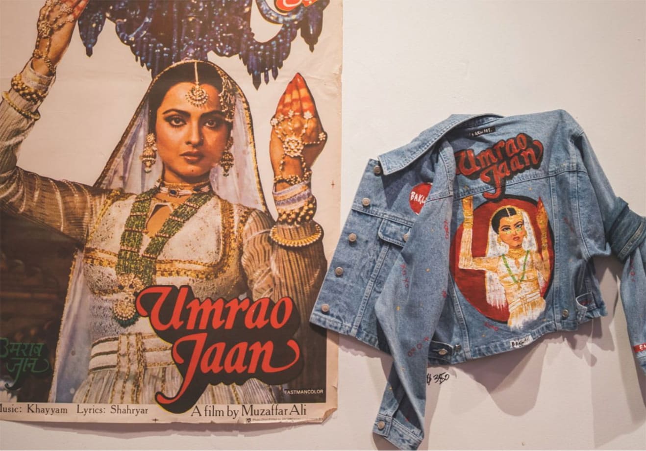 A vintage Bollywood film poster of a women and an artist's painting of the poster on a denim jacket.
