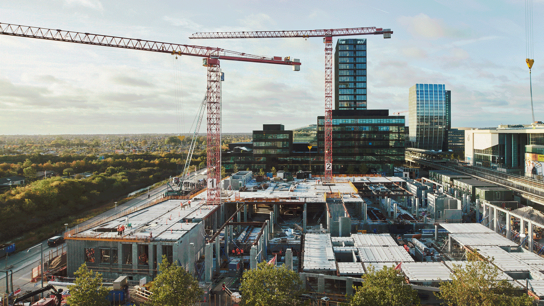/globalassets/images/building-site-images/building-site-cranes-trees.png
