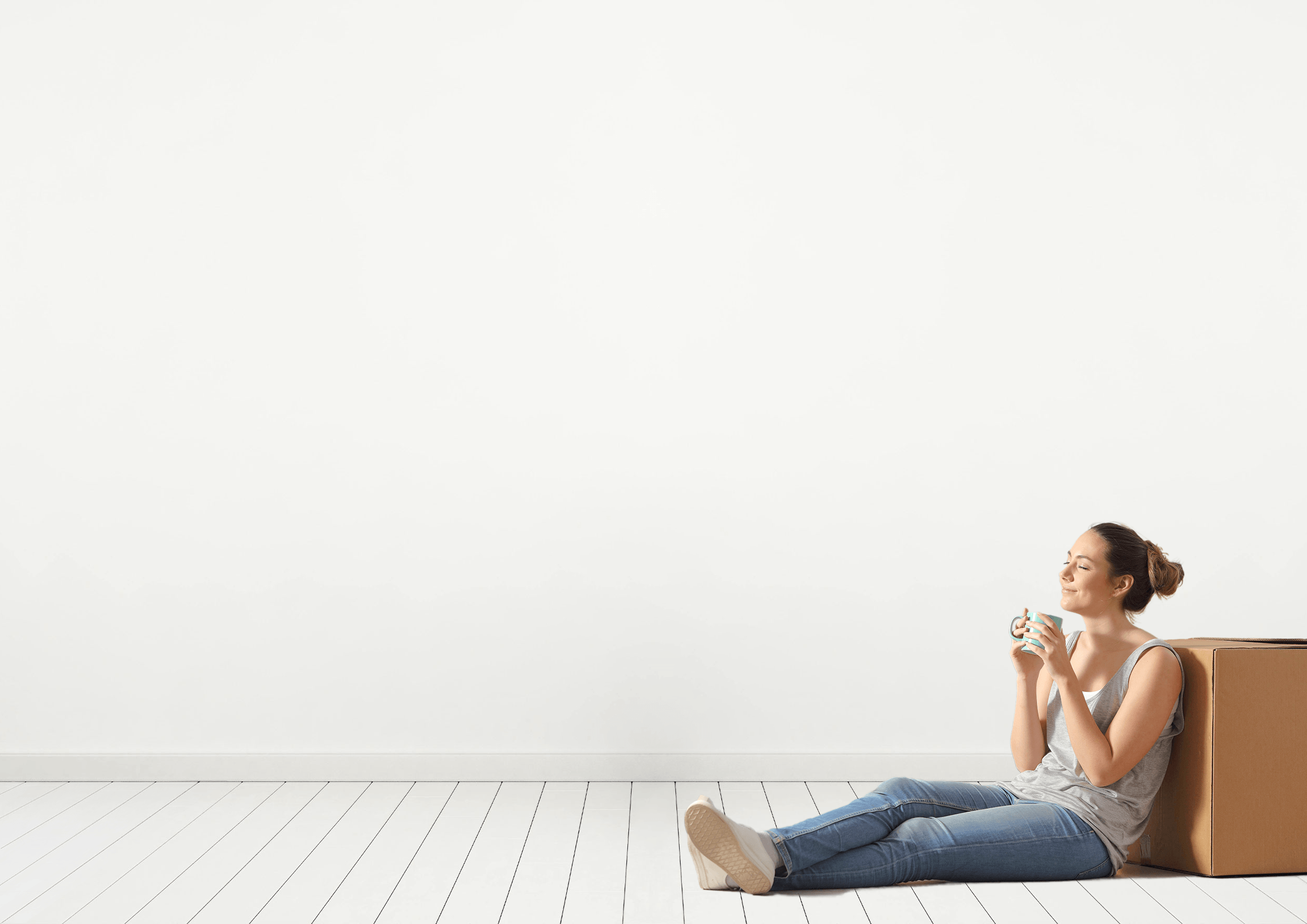 Woman sitting on floor after selling a house with a top SoldNest real estate agent