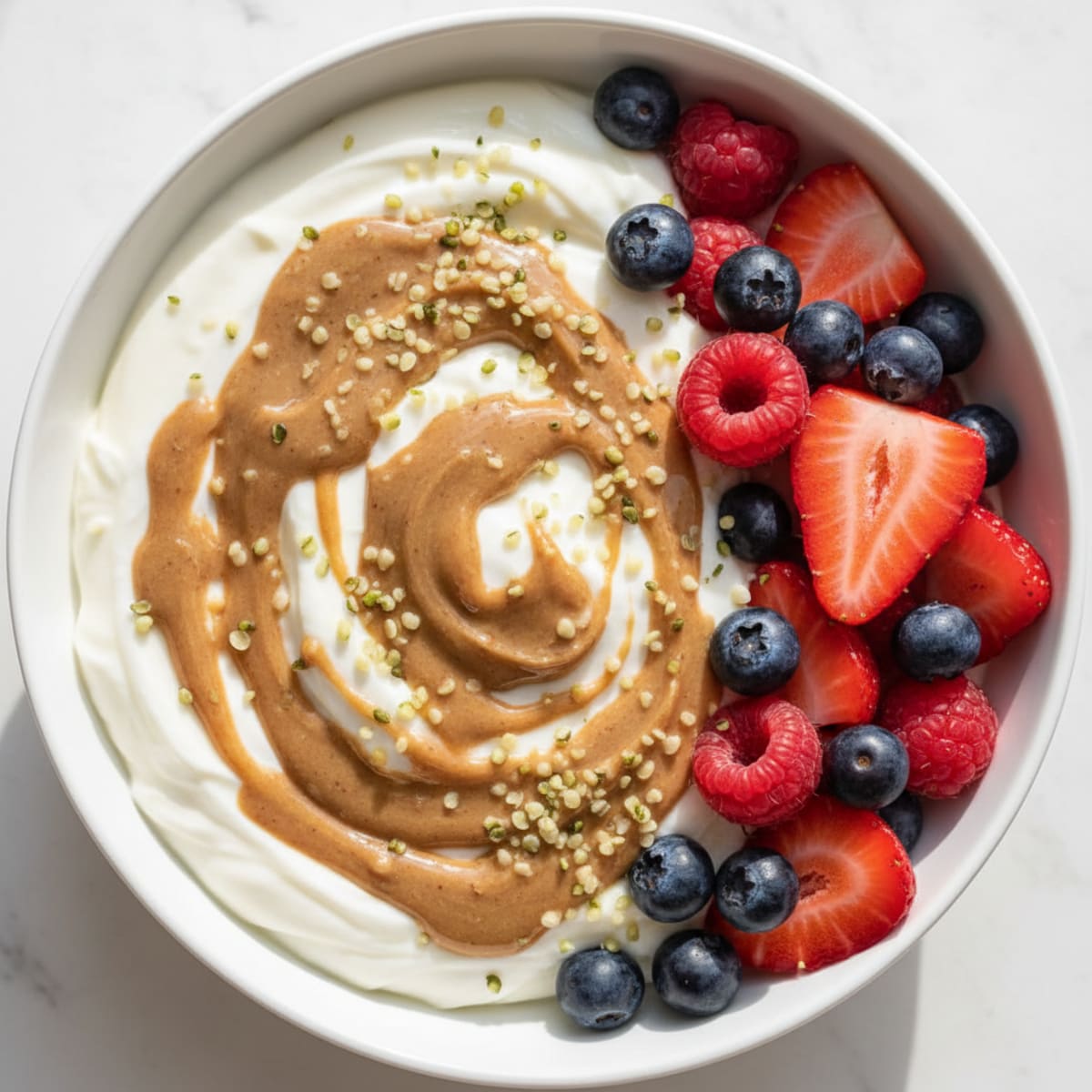 Creamy Vanilla Protein Yogurt Bowl with Mixed Berries and Almond Butter