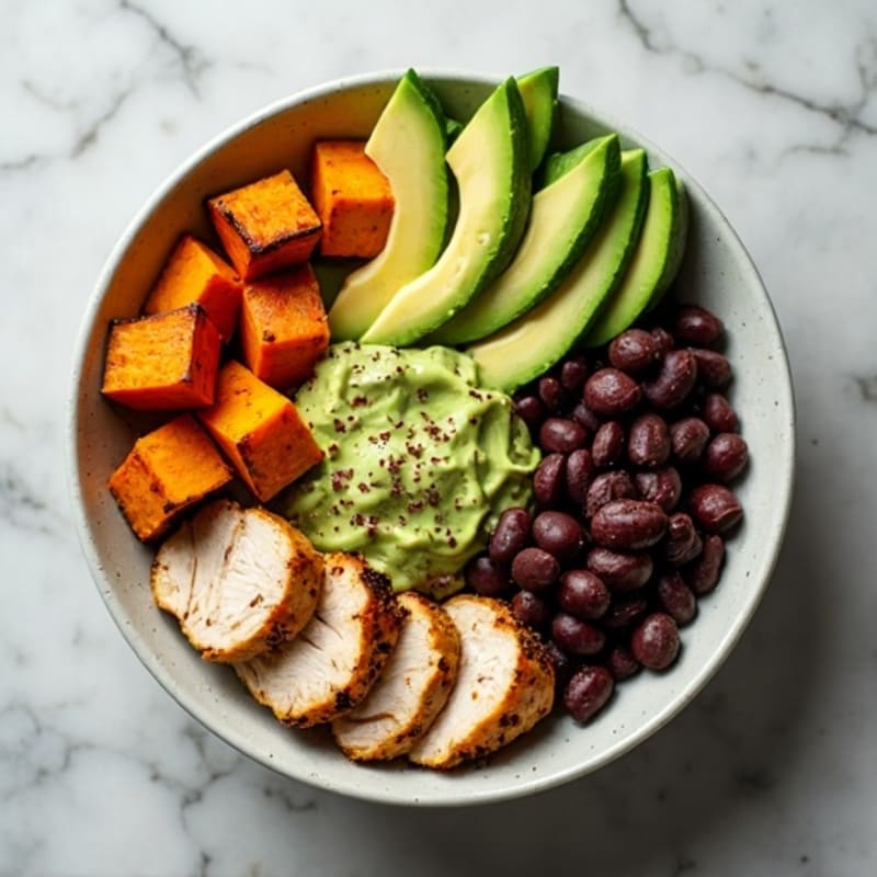 Roasted Sweet Potato and Black Bean Bowl with Creamy Avocado Dressing