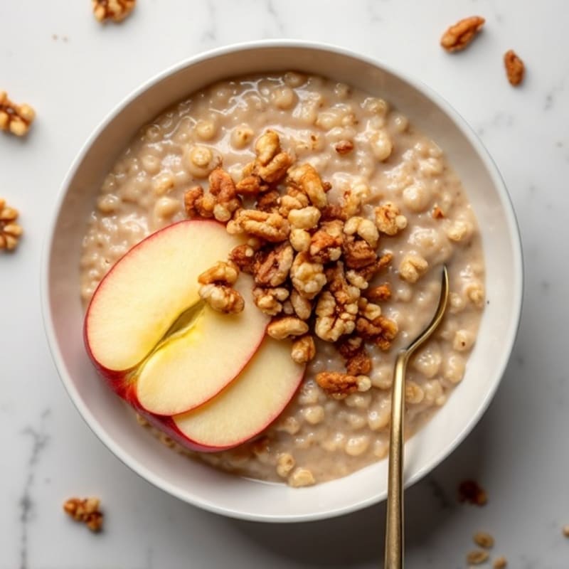 Creamy Cinnamon Protein Oatmeal with Sliced Apples and Crunchy Walnuts