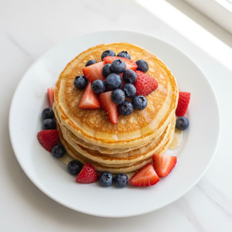 Fluffy Golden Protein Pancakes with Berries