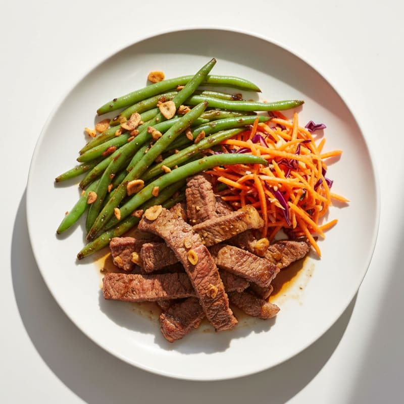 Seared Beef Strips with Garlic Green Beans and Carrot Slaw