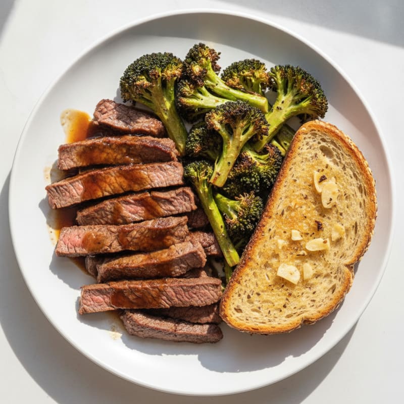 Seared Lean Beef Strips with Roasted Broccoli and Garlic Bread
