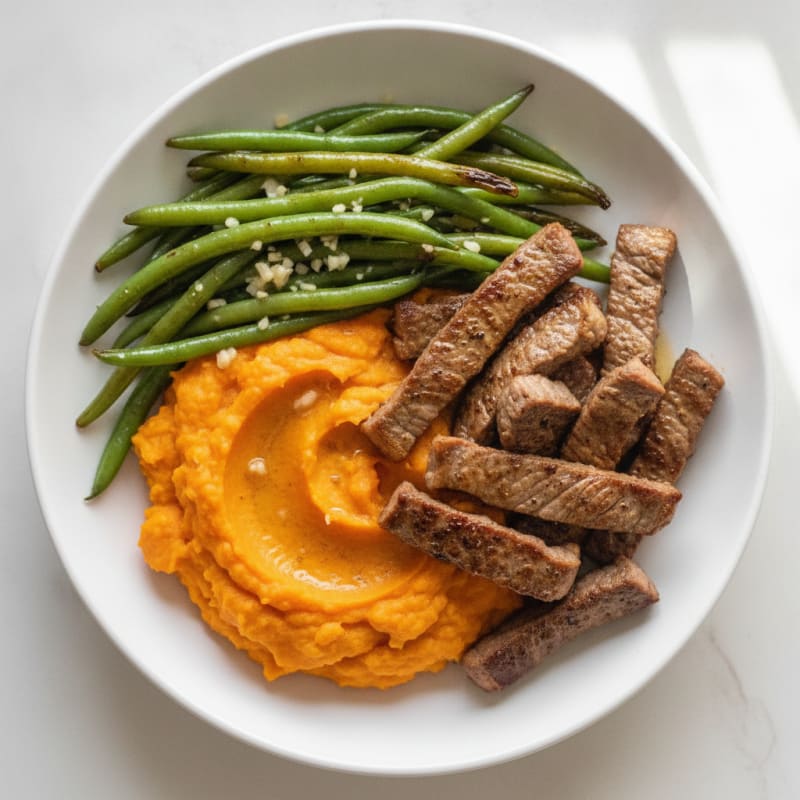 Seared Lean Beef Strips with Garlic Green Beans and Sweet Potato Mash