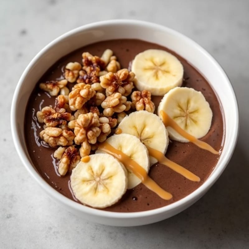 Creamy Chocolate Peanut Butter Protein Bowl with Sliced Banana and Crunchy Walnuts