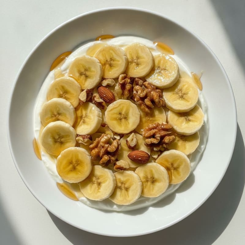 Greek Yogurt Protein Bowl with Mixed Nuts and Sliced Banana