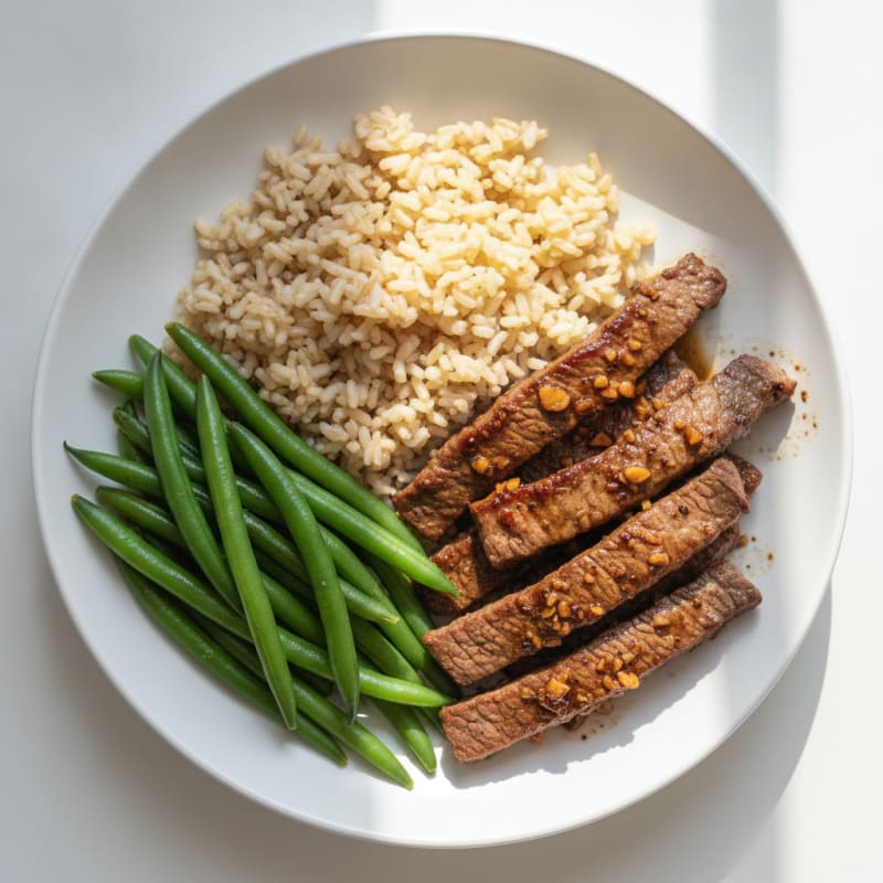 Seared Lean Beef Strips with Steamed Green Beans and Brown Rice