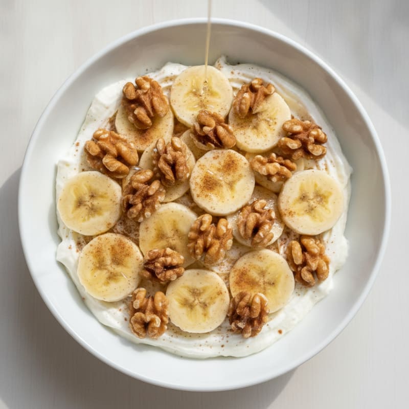 Protein Yogurt Parfait with Toasted Nuts and Sliced Banana
