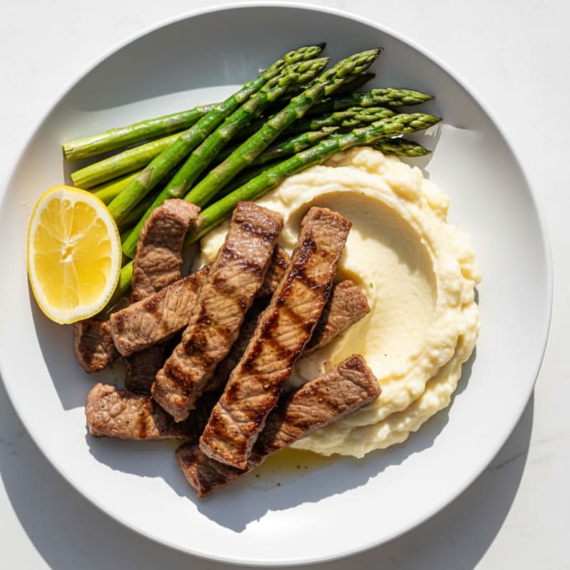 Seared Lean Beef Strips with Steamed Asparagus and Cauliflower Mash