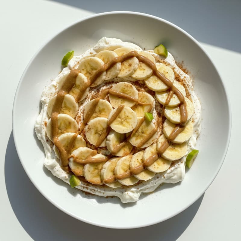 Nonfat Greek Yogurt Bowl with Protein Powder, Almond Butter, and Sliced Banana